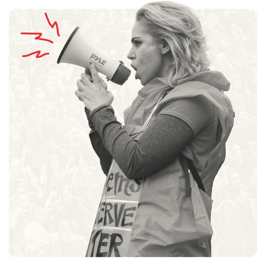 Woman with long hair speaking into a bullhorn.